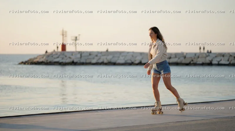Pattini a rotelle sul molo di Rimini, sulla Riviera Romagnola al tramonto