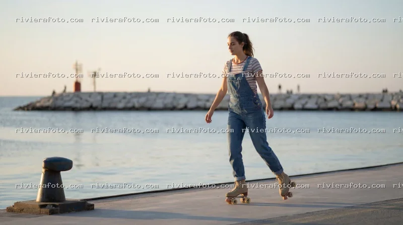 Pattinaggio a rotelle sul molo di Rimini, sulla Riviera Romagnola al tramonto
