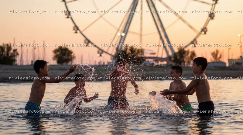 Giochi in acqua al tramonto con la Ruota Panoramica di Rimini