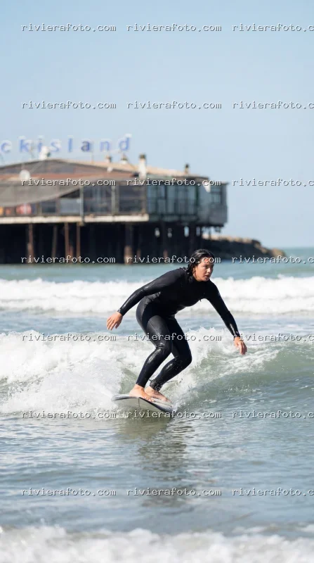 Surf sulla spiaggia di Rimini con Rockisland sullo sfondo